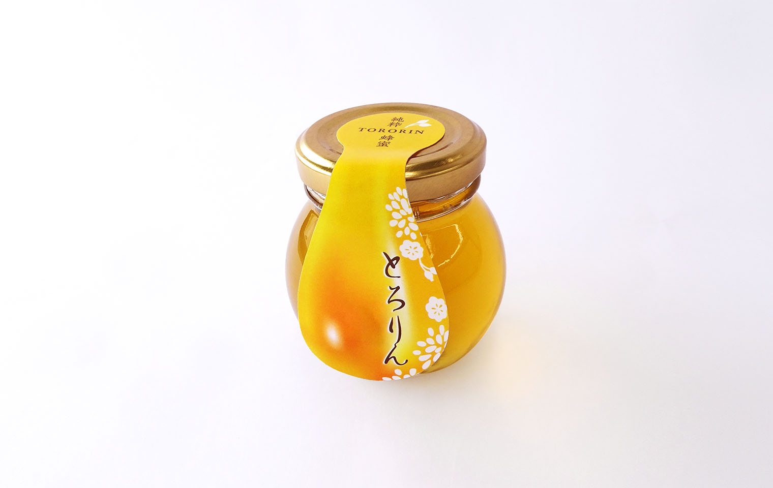 シズル感のあるデザインで商品素材の魅力をアップ。「純粋蜂蜜とろりん」封緘ラベル